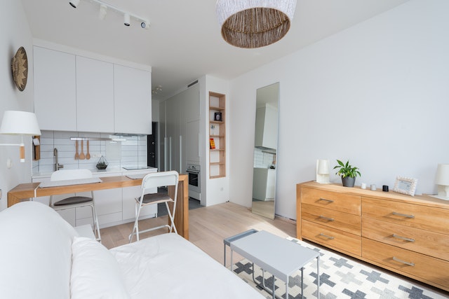 property interior with an open concept living and dining room with light wood flooring and white cabinets